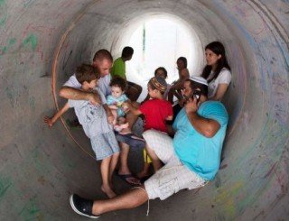 Israelis shelter in a pipe during an attack from Gaza